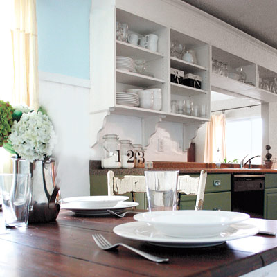farmhouse-style kitchen after remodel with distressed wood dining room table