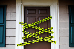 front door with yellow danger tape