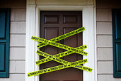 front door with yellow danger tape