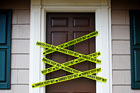 front door with yellow danger tape