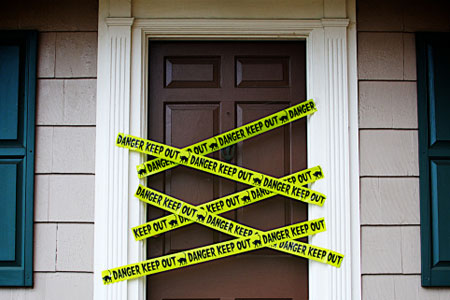 front door with yellow danger tape
