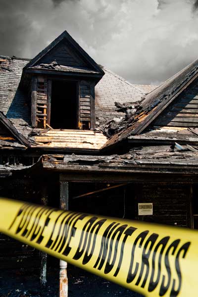 house with police tap blocking entrance after house fire