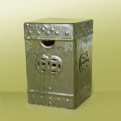 a box-shaped, metallic green ceramic garden stool with rustic design