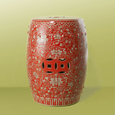 a red ceramic garden stool with Buddhist orchid design