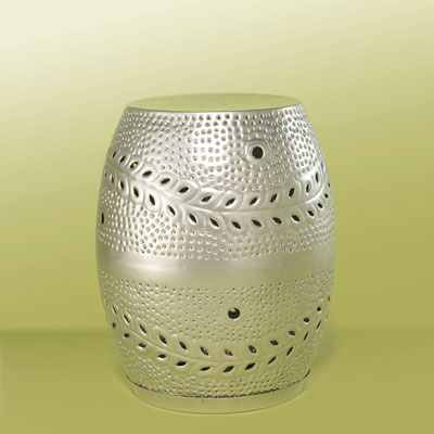 a stainless steel garden stool with hammered and pierced details