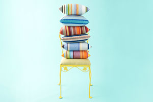 outdoor throw pillows stacked on a chair
