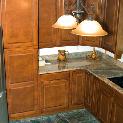 kitchen with granite countertops, slate floor and copper fixtures
