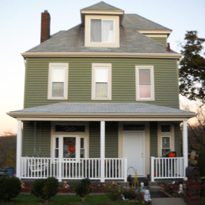 green house with gray roof and front porch 
