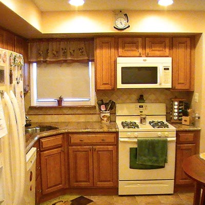 kitchen with wood cabinets, marble countertop, white appliances