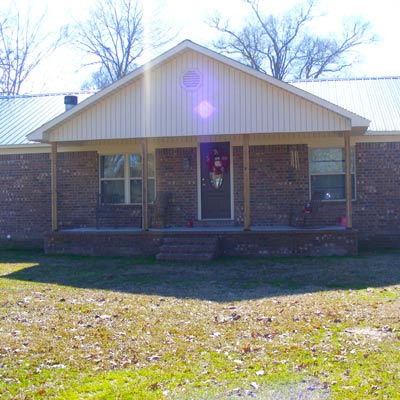trailer with brick exterior and new windows to look like a house