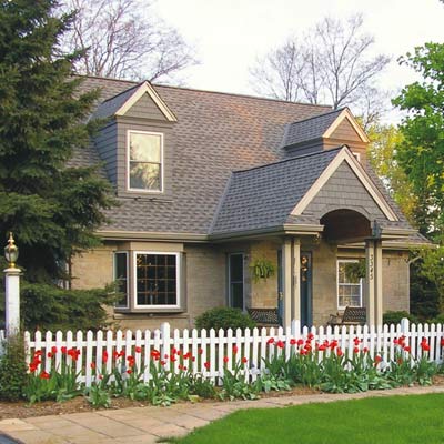 New England style house with white picket fence 