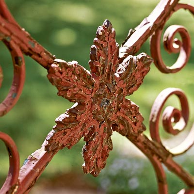 a leaf pattern on a rusted iron gate shot close up