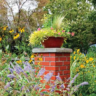 brick garden columns that double as plant stands 