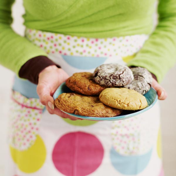 woman standing with plate of cookies