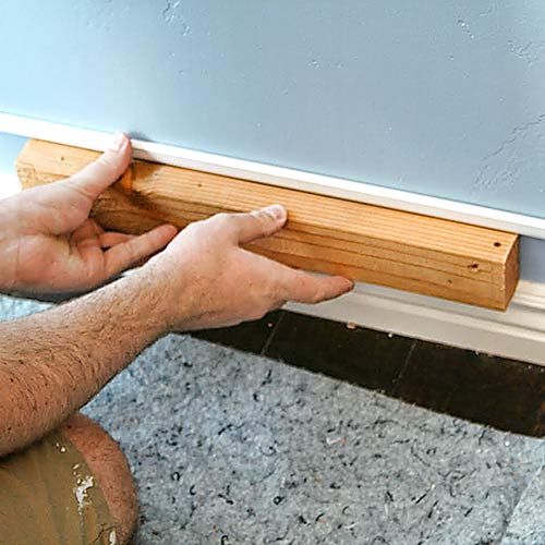 money saving blogger DIY project beefed up baseboards with bead trim step 1