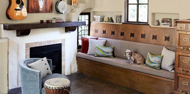 women's den living area with exposed ceiling beams and trusses, and original built-in storage bench
