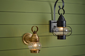 two onion-style porch lanterns on green siding