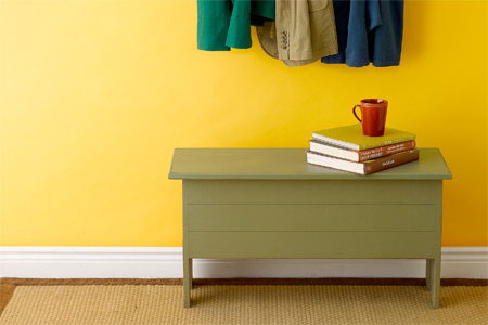 Entryway Benches against a wall with hanging coats