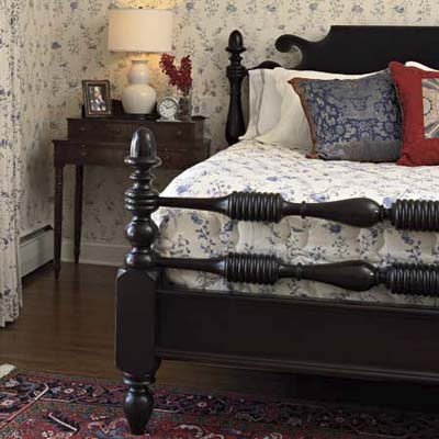 acorn post bed in this remodeled shingle-style cottage