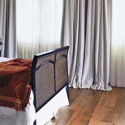 reclaimed heart pine blends with the neutral tones in this bedroom