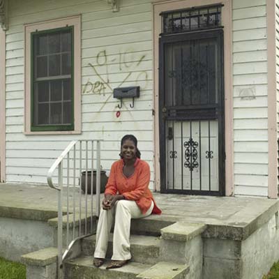 homeowner Rashida sitting on the steps of New Orleans house