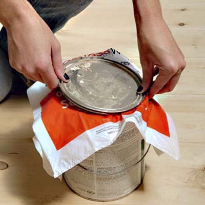 plastic bag placed between a paint can and lid to keep the paint clean and flake-free