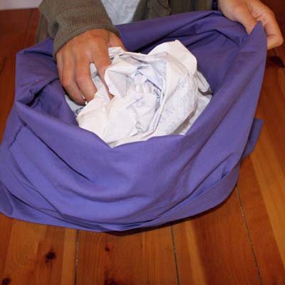 plastic bags stuffed into a pillowcase for a pet's bed