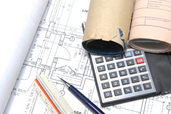 ruler, calculator, building plans on a table