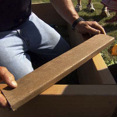 a piece of scrap lumber held at the corners to hold them at a right angle