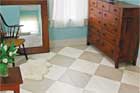 a bedroom painted in a beige and white diamond checker pattern