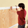 attaching the trim to hide the beadboard edges on the mudroom bench