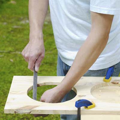 this old house editor mark powers using a rasp to ease the freshly cut dish holes