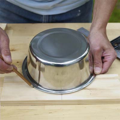 this old house editor mark powers marking where the tray handles go with a pencil