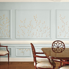 an interior wall patterned with hand-painted branches and leaves