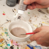 paint being mixed with water in a bowl