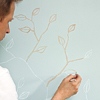 paint applied to chalk sketch of leaves and branches