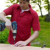 man using a drill driver to screw attach the bottom to the pet ramp box