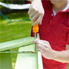 hands using a screwdiver to fasten the hardware to the pet ramp