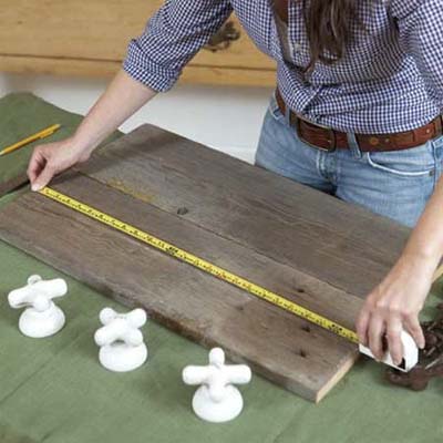 tape measure across a board to be used for mounting vintage taps as hooks