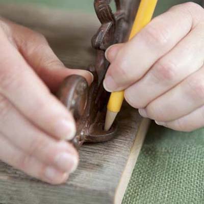pencil marking the position where the bracket fasteners will go for this vintage porcelain tap towel rack