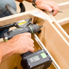 Tom Silva fastening two stock cabinets together