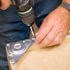 Tom Silva attaching foot plates to the bottom of the joined cabinets