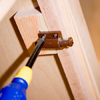 Tom Silva mounting door latches to the inside of the cabinet doors