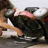 Drain the mower's oil into a pan; be sure to spread tarp beneath for easy clean-up
