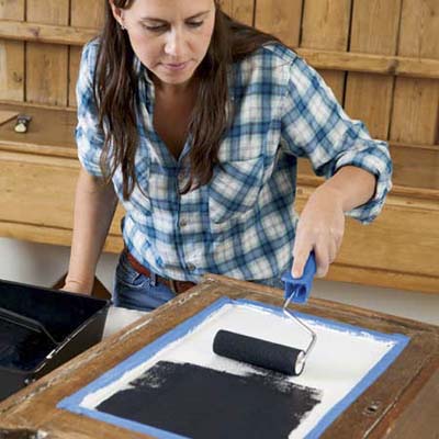 applying chalkboard paint to outside of cabinet door
