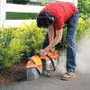 Mark Powers saws into a concrete driveway