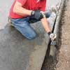 Mark Powers chops excess asphalt into small chunks for easy removal