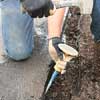 removing rough edges from a newly cut asphalt driveway edge