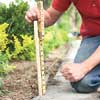 staking a level line for edging on an asphalt driveway