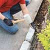pounding in the edging block with a rubber mallet
